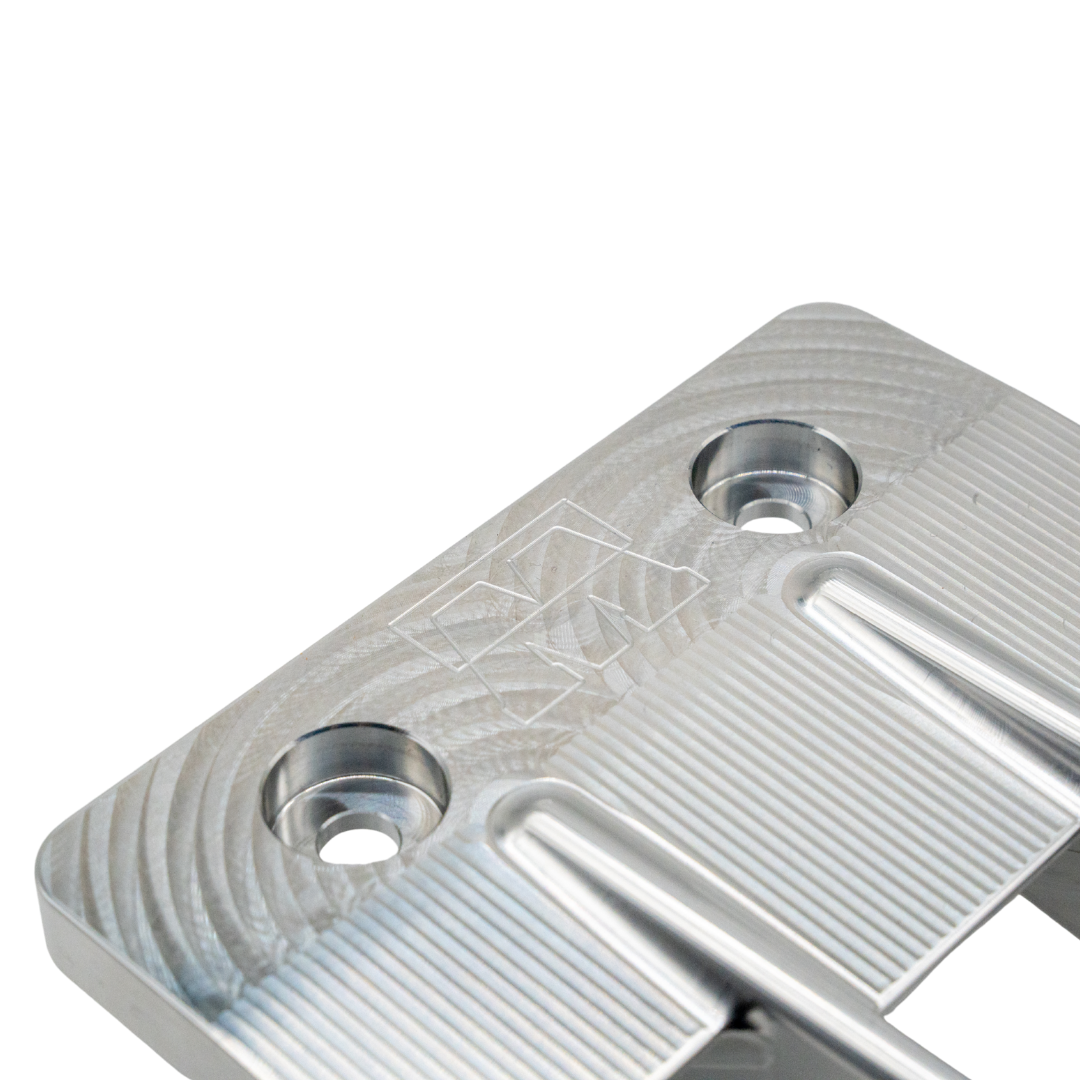 Close-up of countersunk mounting holes and engraved Worx logo on the WR250 Signature Series billet intake grate