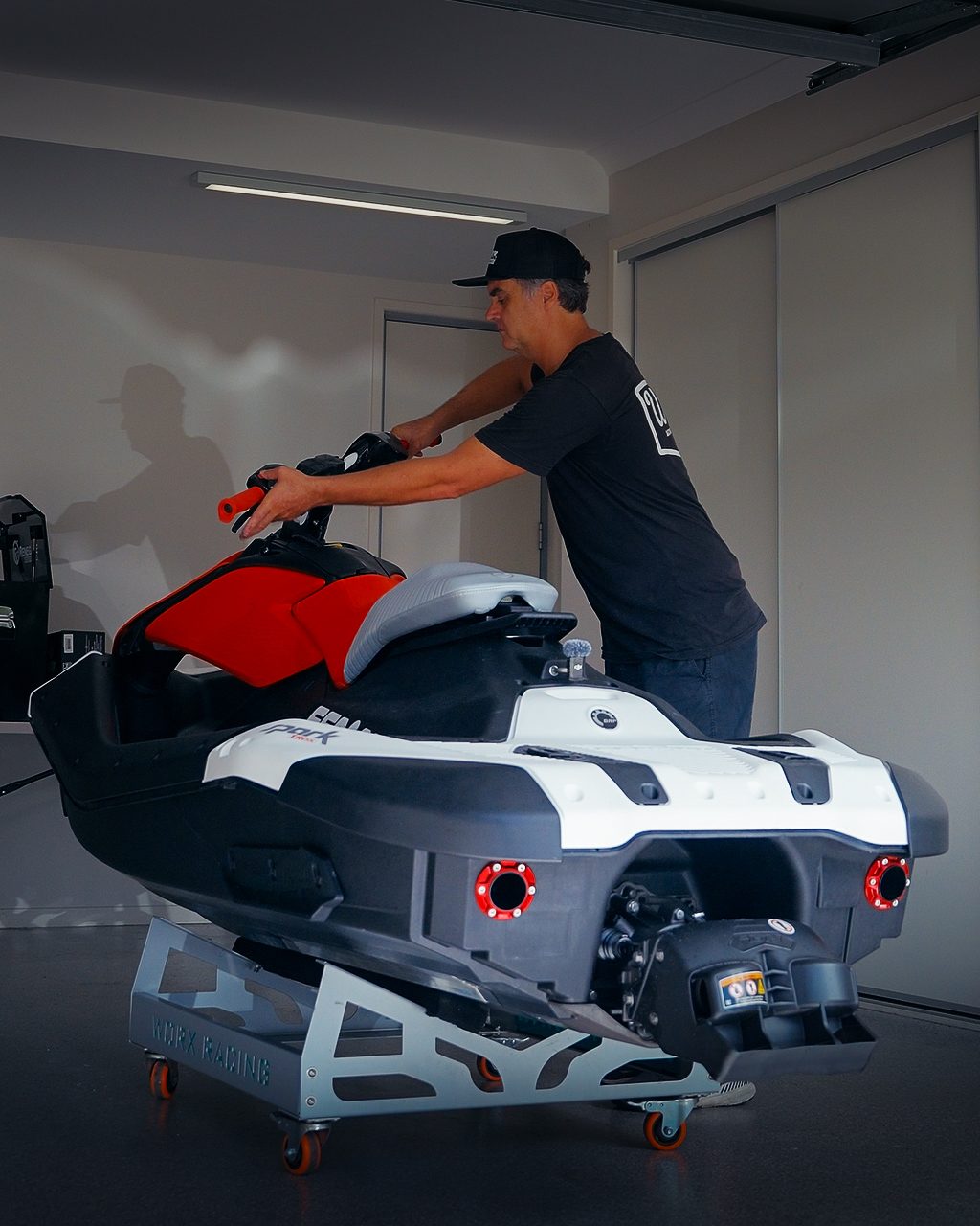 Sea-Doo Spark on a WORX ski dolly in a home garage with dual rear exit exhaust