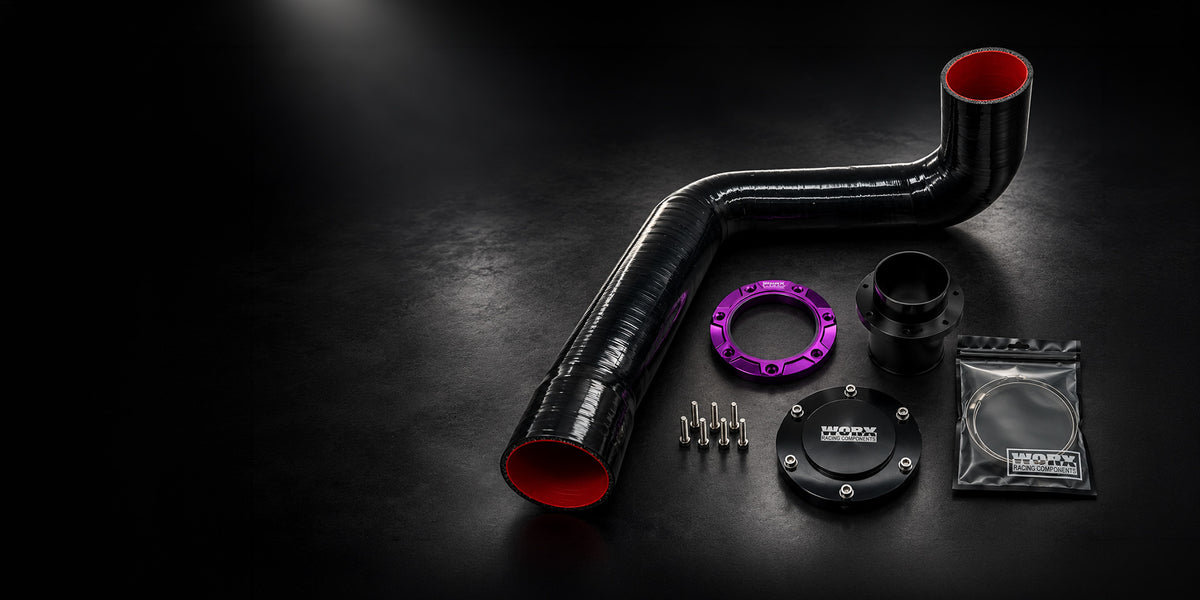 Contents of the WORX Yamaha GP and VX rear exhaust kit: silicone hose, Ultra Violet outlet ring, bulkhead, block off plate, stainless bolts and hose clamp